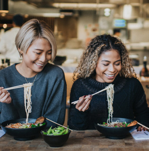 women enjoying wagamamas' ramen